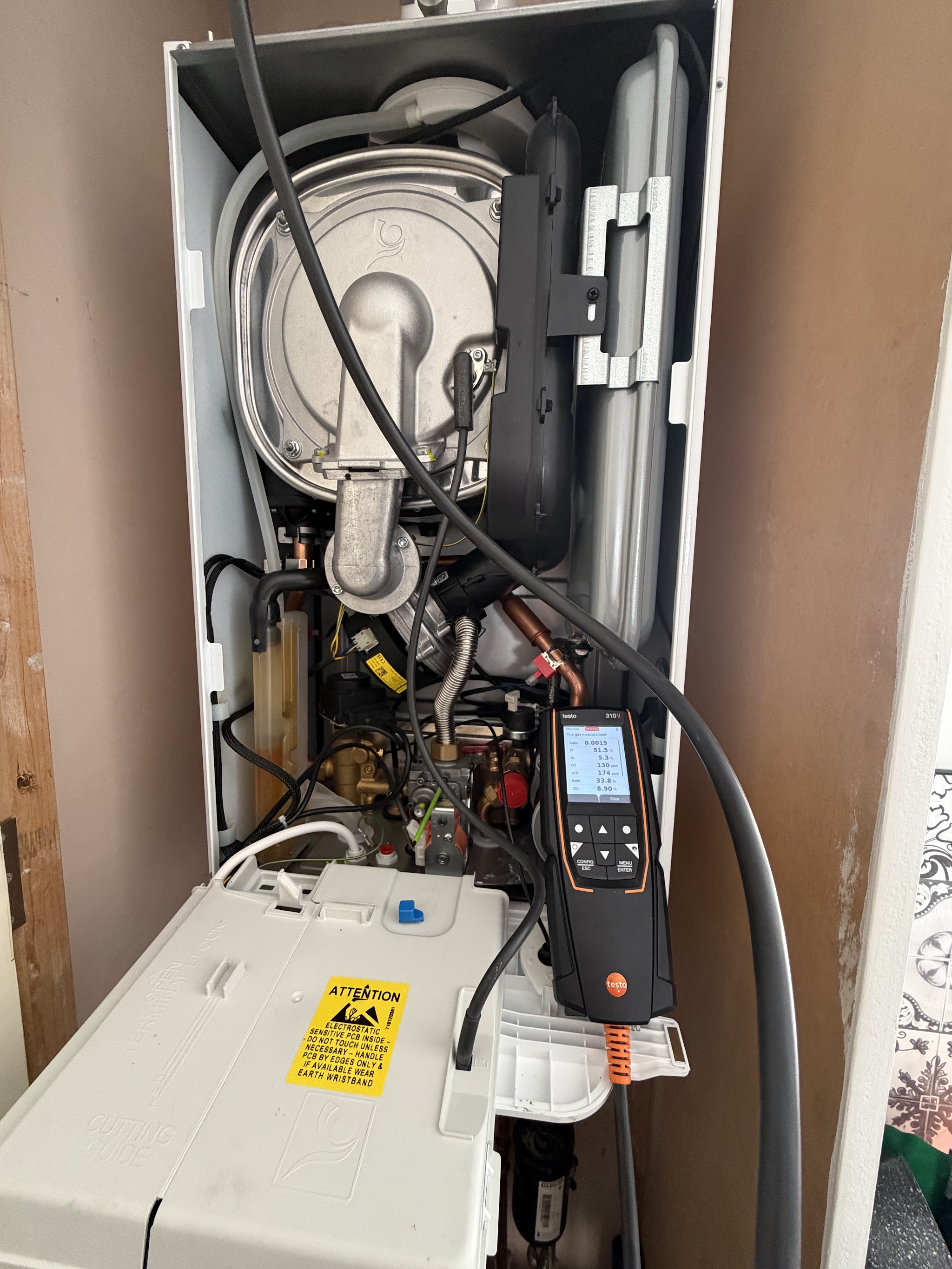 Boiler opened up for a service with a flue gas analyser connected