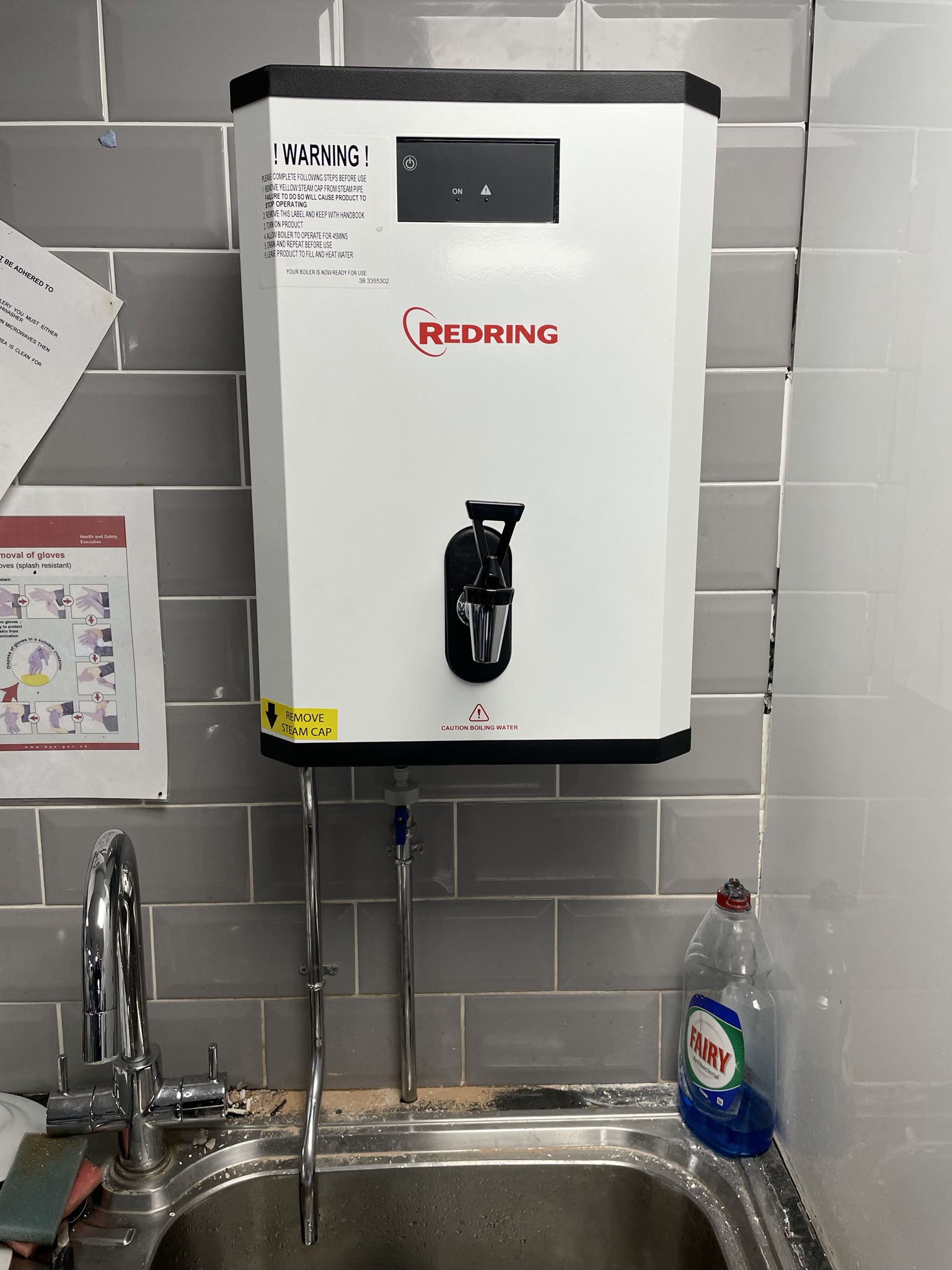 Wall-mounted Redring water heater above a sink