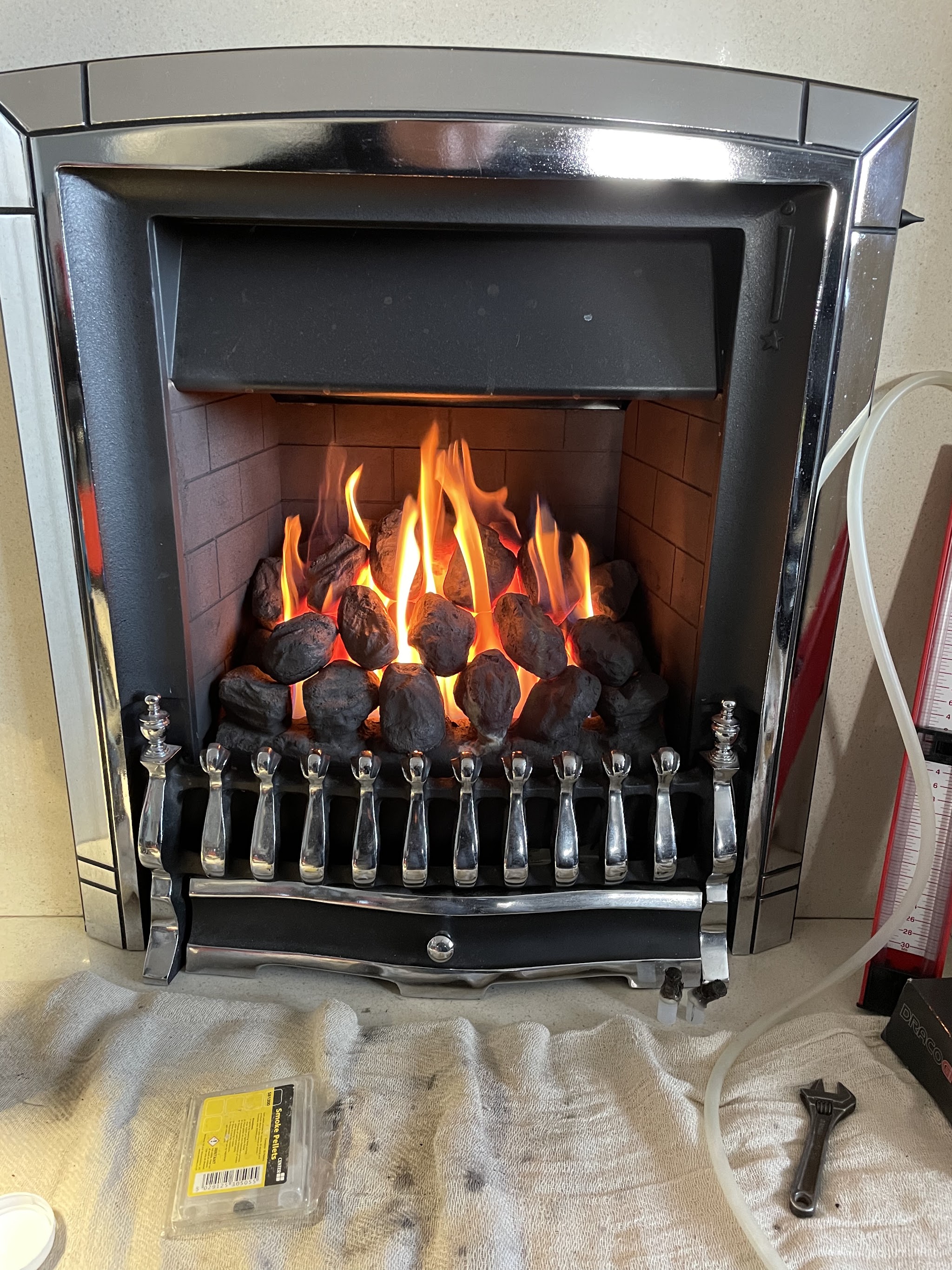 Gas fire lit in a chrome surround